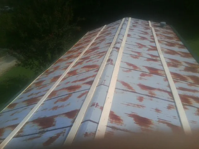 Rusted metal roof panels with new wood purlins before replacement — Storm Damage Roof Repair in Pratts by Roofing Brothers